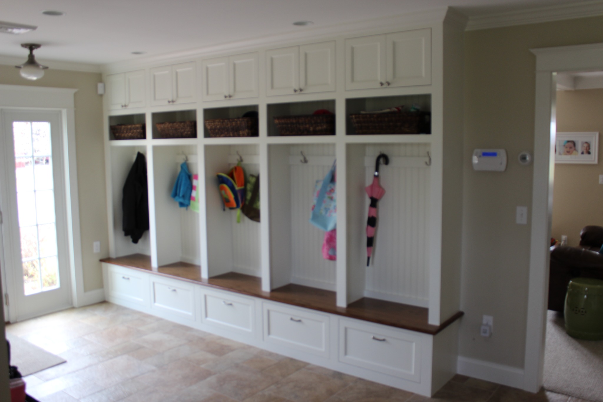 Custom mudroom locker system with bench seating and hooks