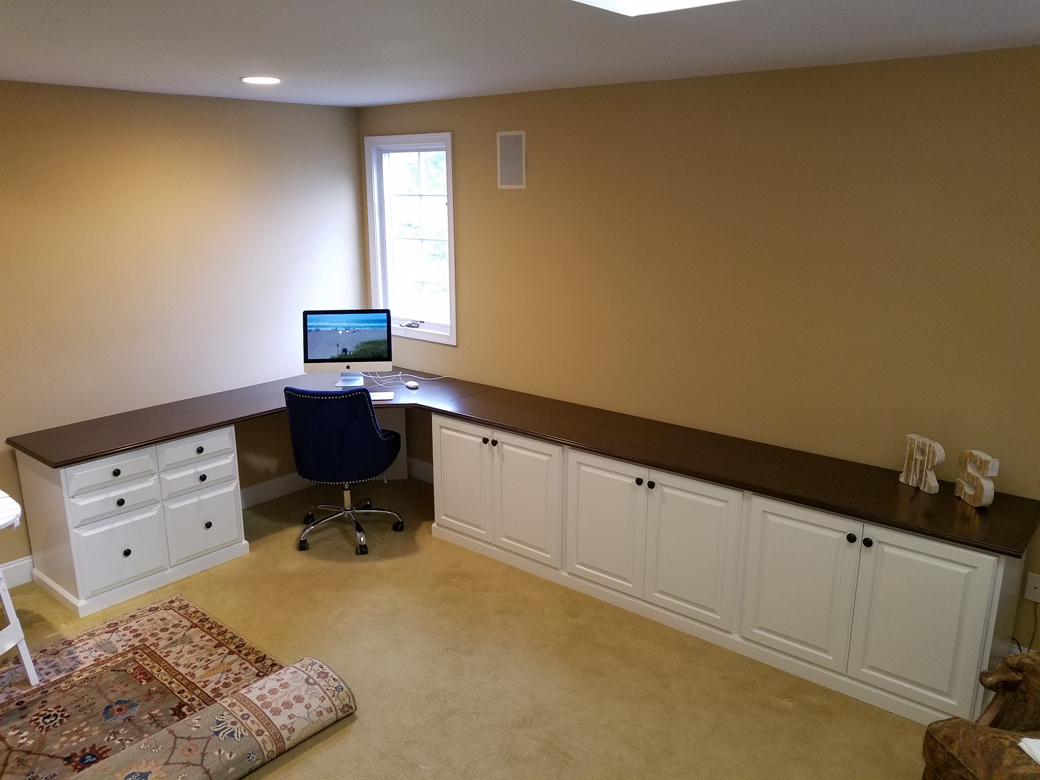 Custom built-in home office desk with drawer storage and shelving
