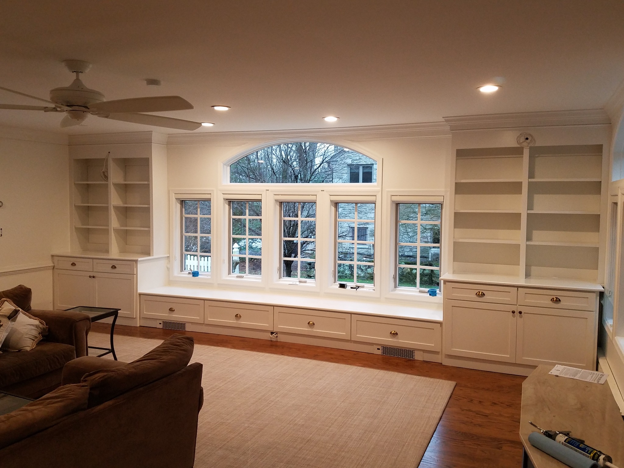 White custom built-in cabinetry surrounding a window wall with bench seating