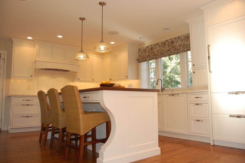 White painted custom kitchen cabinetry with a large island and full-height storage