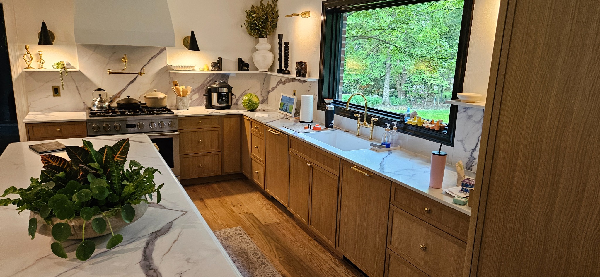 Natural wood frameless full-overlay kitchen cabinetry with wide drawer banks