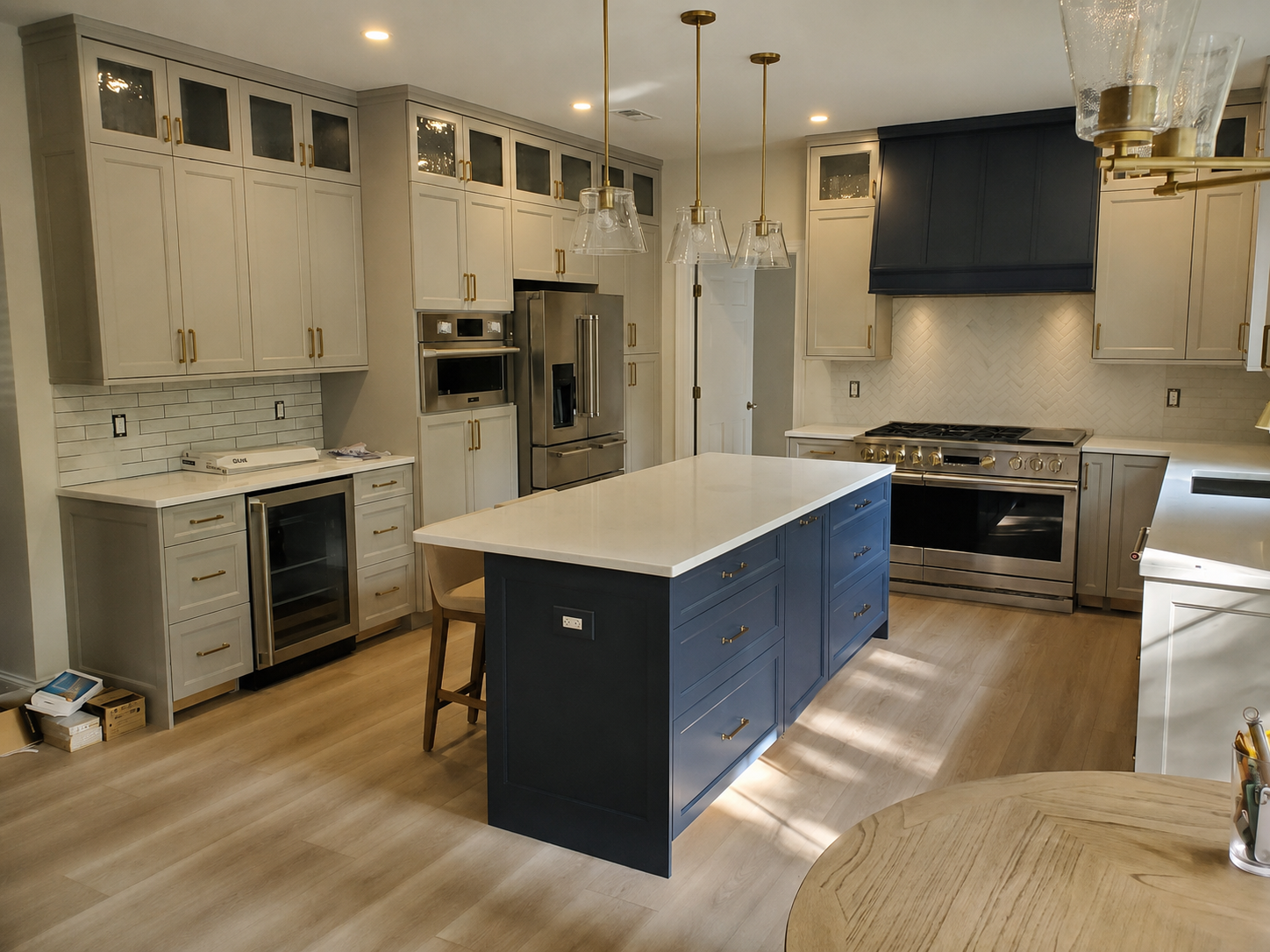 Custom kitchen with painted full-overlay cabinetry, glass-front upper doors, a deep blue island and a matching custom hood, built by Brobst Custom Cabinetry & Design LLC