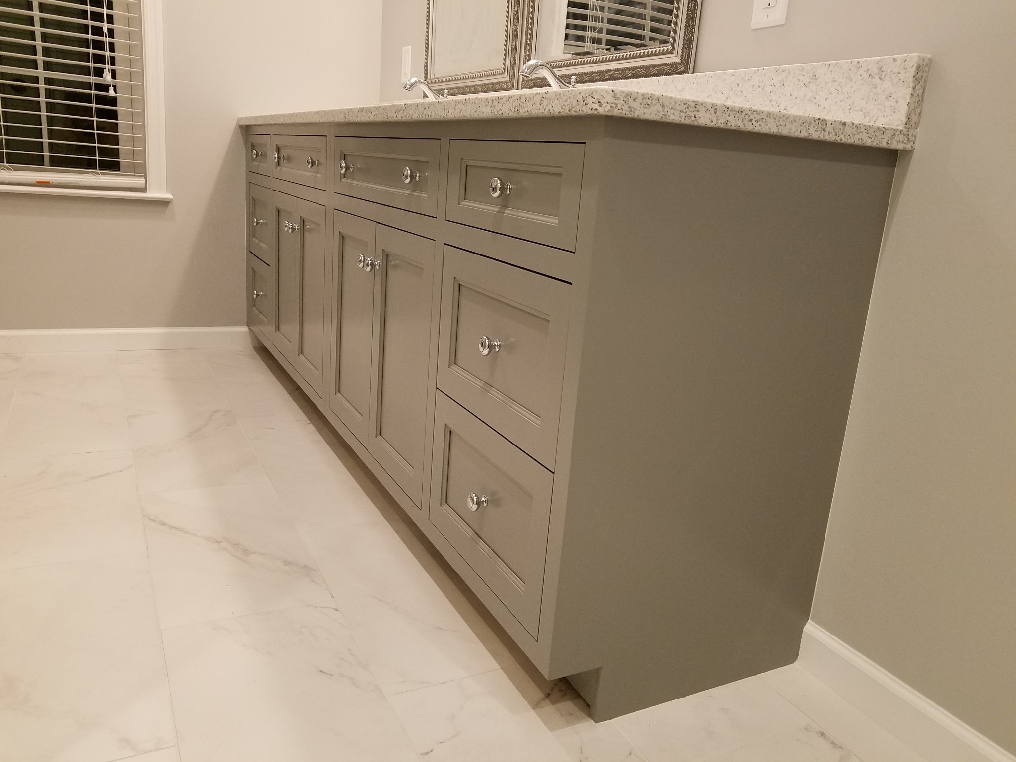 Gray flush-inset custom bathroom vanity with fitted doors and drawers